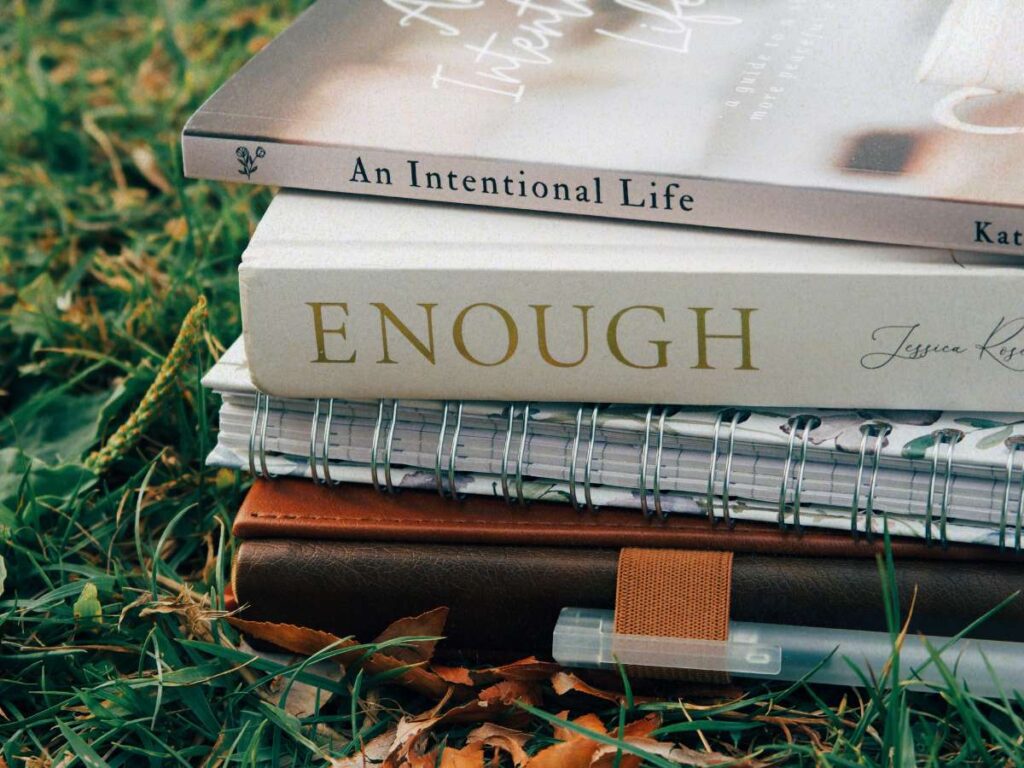 A stack of books signifying a busy lifestyle and the requirement to learn how to keep on top of housework