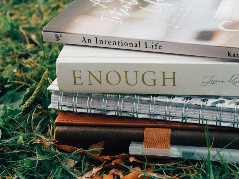 A stack of books signifying a busy lifestyle and the requirement to learn how to keep on top of housework