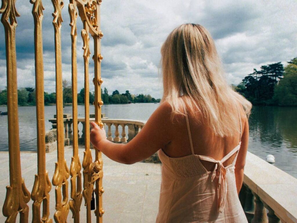 Lucie walking through a gate to signify her dream of moving to a new house