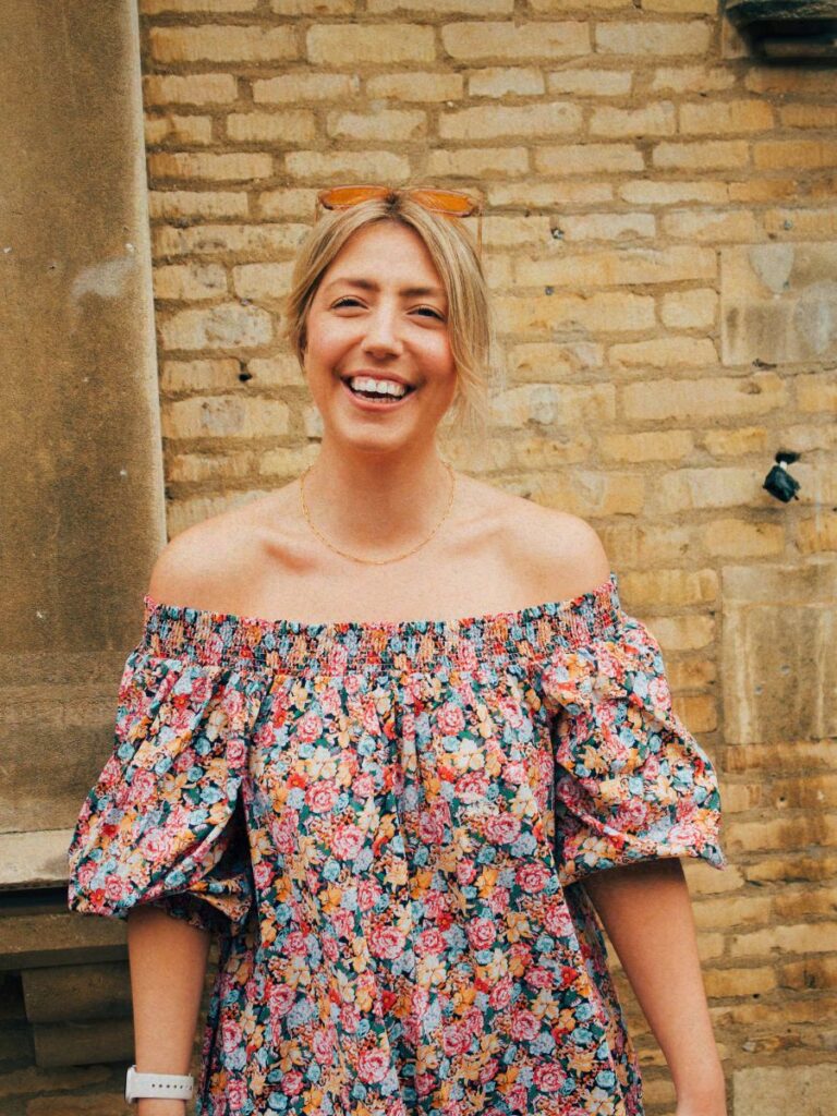 A photo of Lucie smiling to the camera, signifying learning to be the best version of yourself